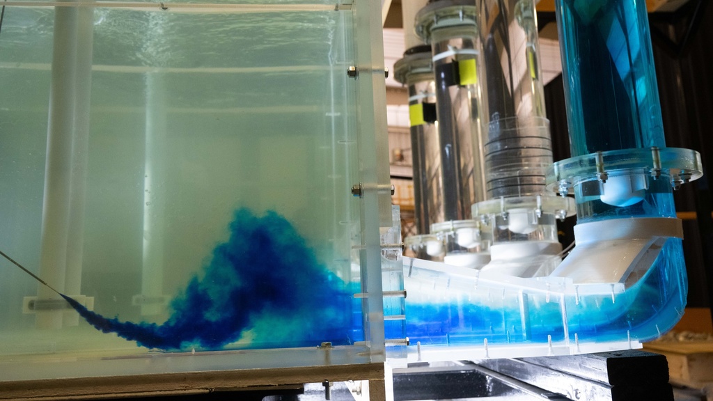 A shot of the dubuque bee branch pump station from the side, with a blue liquid being shot into the tube to see flow