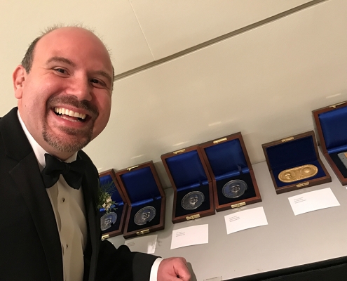 Gabriele-Villarini stands in front of the AGU Awards