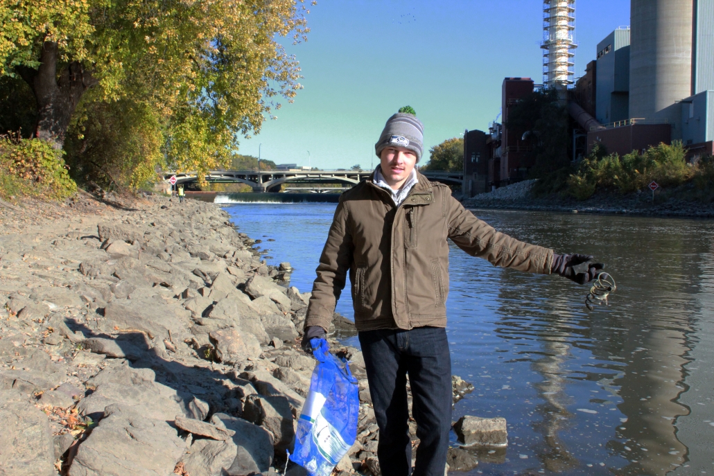 A volunteer holds a bike lock on the bank of the Iowa River