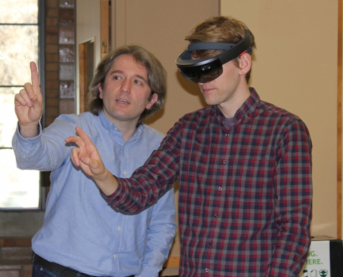 A reporter from the Cedar Rapids Gazette tries out the AI goggles with help from