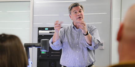 Jerry Schnoor speaks in front of an audience about climate change.