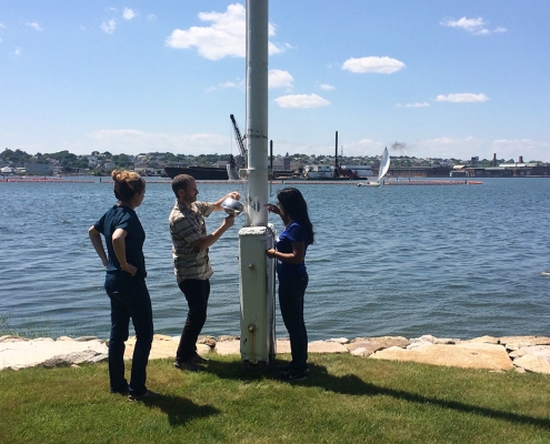 IIHR's Andres Martinez (center) adjusts a sensor measuring airborne PCBs near the New Bedford Harbor in Massachusetts.