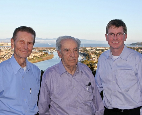 Three men pose in front of a river. They are (left to right) Jacob Odgaard, Rex Elder, and Larry Weber.