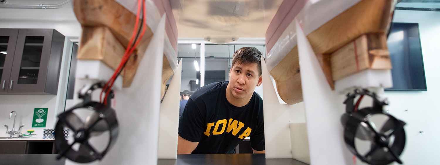 A male student checks out a ship model