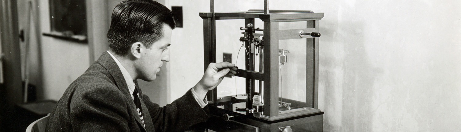 Black and white vintage image of Hunter Rouse working with a scientific instrument